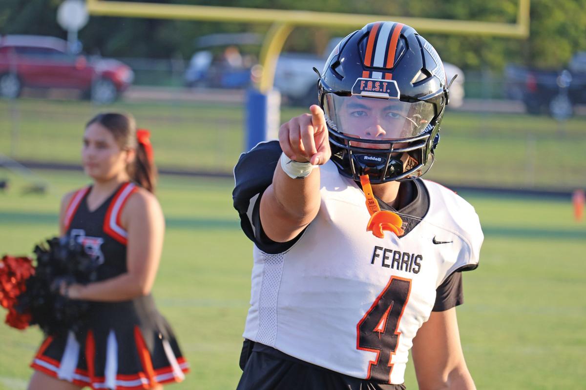 At the start of the game against Peaster, Gavin Garcia (4) runs with the team out of the tunnel and hypes up the crowd. Photo by Josiah Harris, Ferris High School.