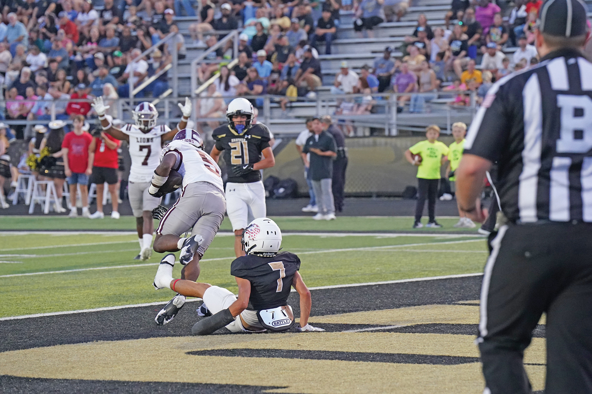 Ennis’s Wenderius Jones (5) gets spun around after a hit in the end zone early in the first quarter. Jones would rush for 272 yards and six touchdowns in the win. Photo by Lezley Norris.