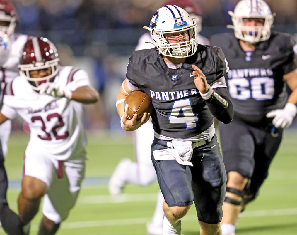 Midlothian quarterback Beau Wendel (4) breaks through the Hawks defense for another Panther touchdown. Photo by Steve Patterson / Moving Pictures.