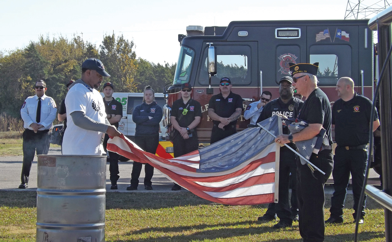 Following the run, members of the color guard marched in, and the brevity of Veterans Day hit hard as Mayor Brown and the American Legion’s S. Gus Alexander Post 111 honored the American flag by performing the flag retirement and disposal ceremony. Photo by Charlotte Dickinson / The Ellis County Press.