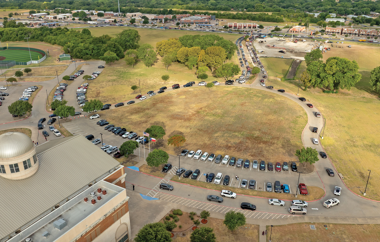 Photo by Steve Patterson / Moving Pictures A view from above Red Oak High School shows the long entrance and exit lines on the first day of school on Aug. 12, 2026. Photo by Steve Patterson / Moving Pictures