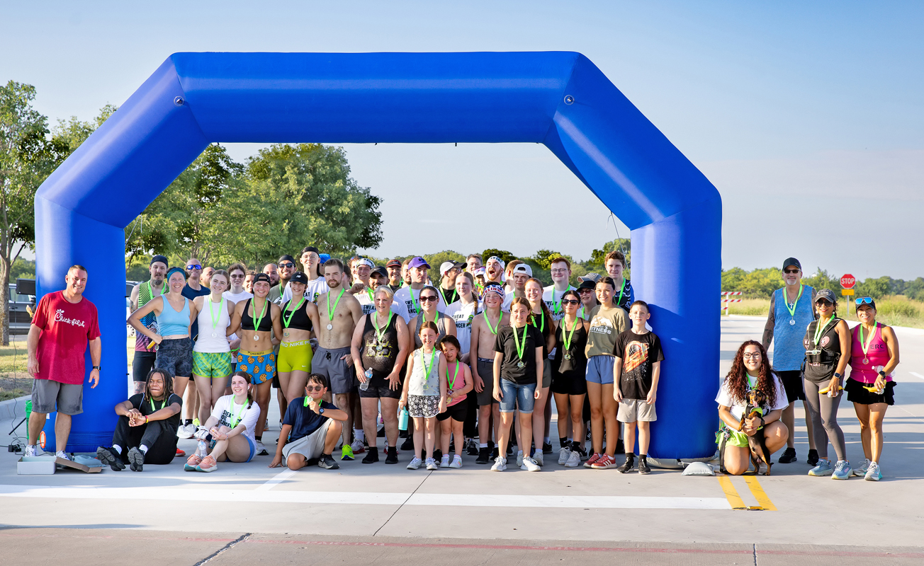 Participants from the first-ever Sweat Out Cancer 5K Fun Run and Walk pose for a group photograph. Main sponsors for the event were Chick-fil-A and the City of Red Oak. Photo by Steve Patterson / Moving Pictures.