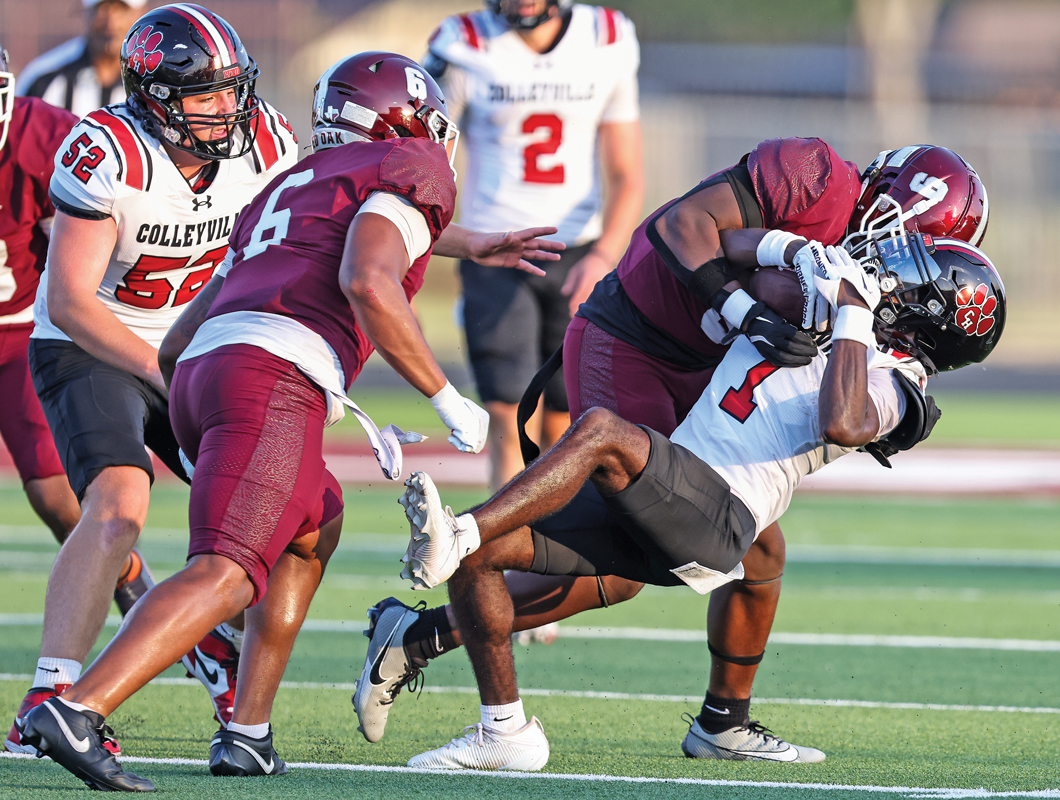 Linebackers Desmond Cox (5) and Courtney Gordon (6) made the night miserable for the Colleyville quarterback, including this 1st quarter sack. Photo by Steve Patterson / Moving Pictures.