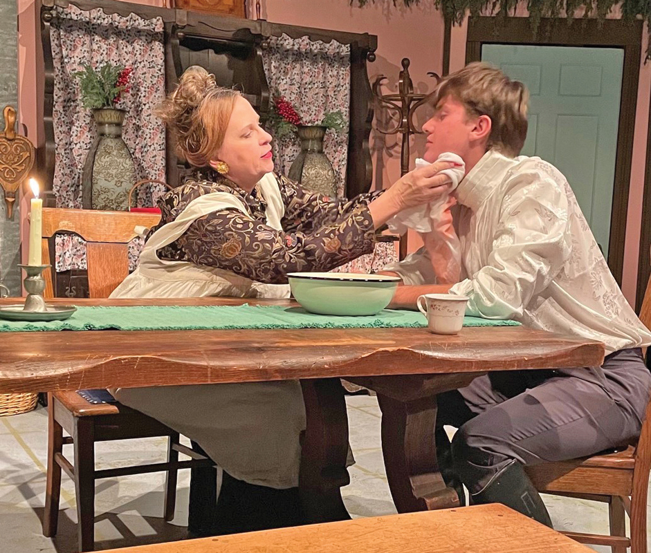 Pemberley housekeeper Mrs. Reynolds (Kelly Kovar) tends to the wayward George Wickham (Nathan Colley) in the Theatre Rocks! production of “The Wickhams: Christmas at Pemberley.” Submitted photo.