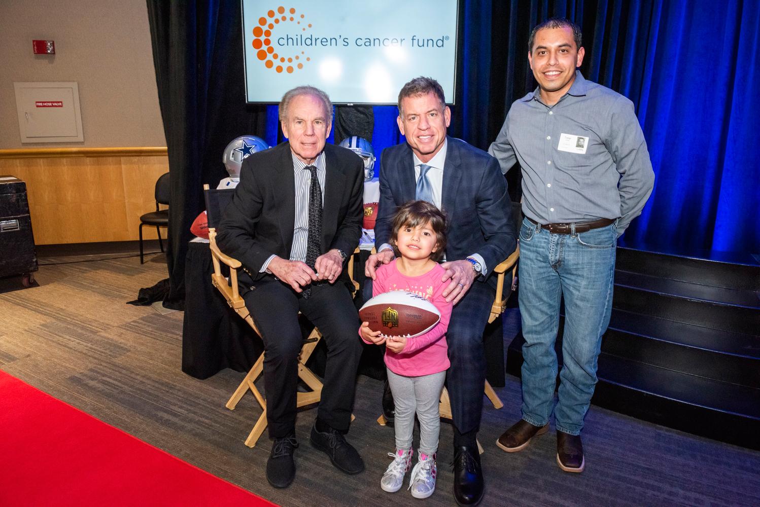 Adiela Tobar and her dad Jesse Tobar meet Honorary Co-Chairs Troy Aikman and Roger Staubach during the autograph session of the photo shoot for this year’s gala.