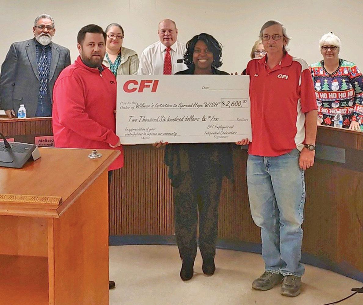CFI’s Wilmer employees visited City Hall last night to make a ceremonial check presentation. Pictured on the back row (L-R) are: Sergio Campos, Melissa Ramirez, Jeff Steele, Candy Madrigal and Phyllis Slough. Front row (L-R) are: Patrick Meilinger, Mayor Emmanuel Wealthy-Williams and Greg Shaw.
