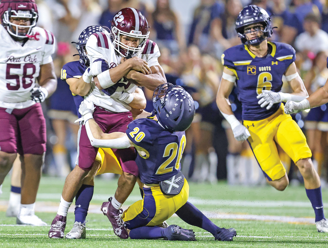 Renard Thomas (4) picks up a Hawks first down out of the backfield on this carry. Photo by Steve Patterson / Moving Pictures.