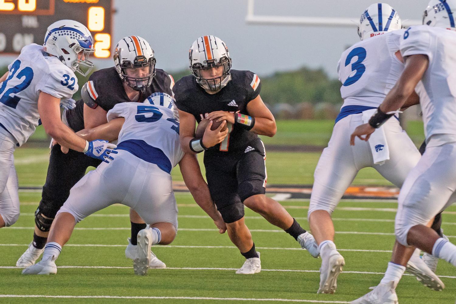 Ferris Quarterback Nate Aguinaga ran 24 times for 112 yards and a touchdown in the loss to Quinlan. Photo by Kirk Holt.