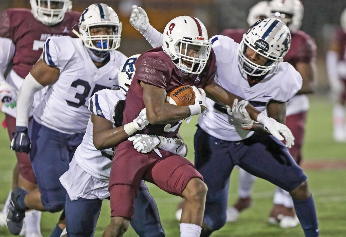 Hawks RB Zachary Sanders (9) carries a few defenders towards the end zone in the 2nd quarter. Photo by Steve Patterson / Moving Pictures.