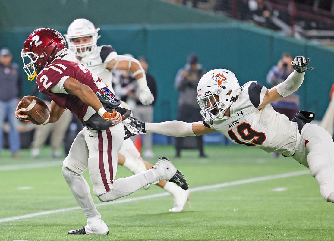 On a pass from quarterback Chris Martinez, wide receiver Brayden Robinson (2) splits the Bearcats defenders on his way to the endzone.