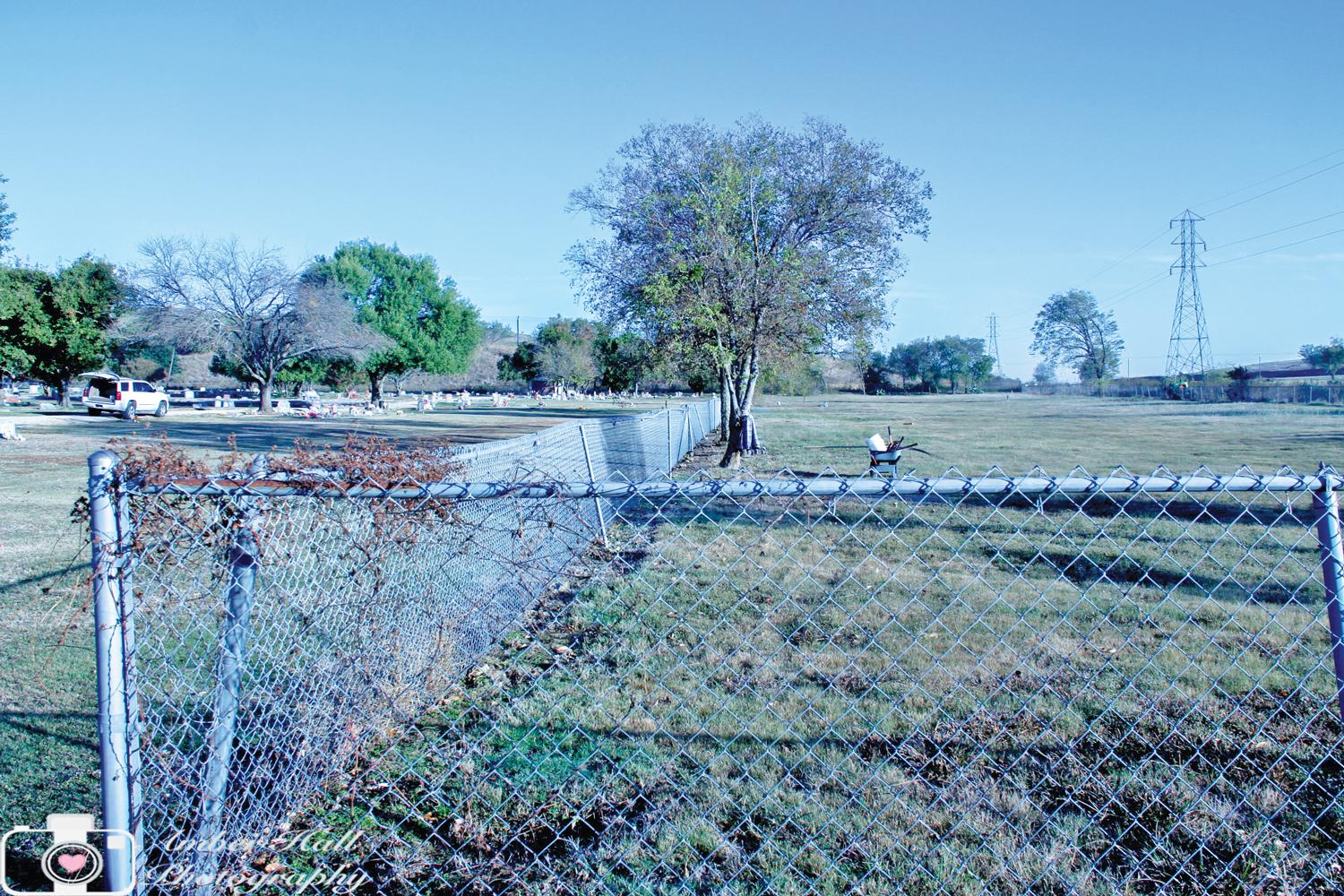 Unity  in the Community volunteers tore down a chain-link fence separating the white cemetery from the black cemetery. Amber Hall said a little history of the cemetery includes the fact is was once known as the “colored cemetery,” thus the reason for the chain link fence.