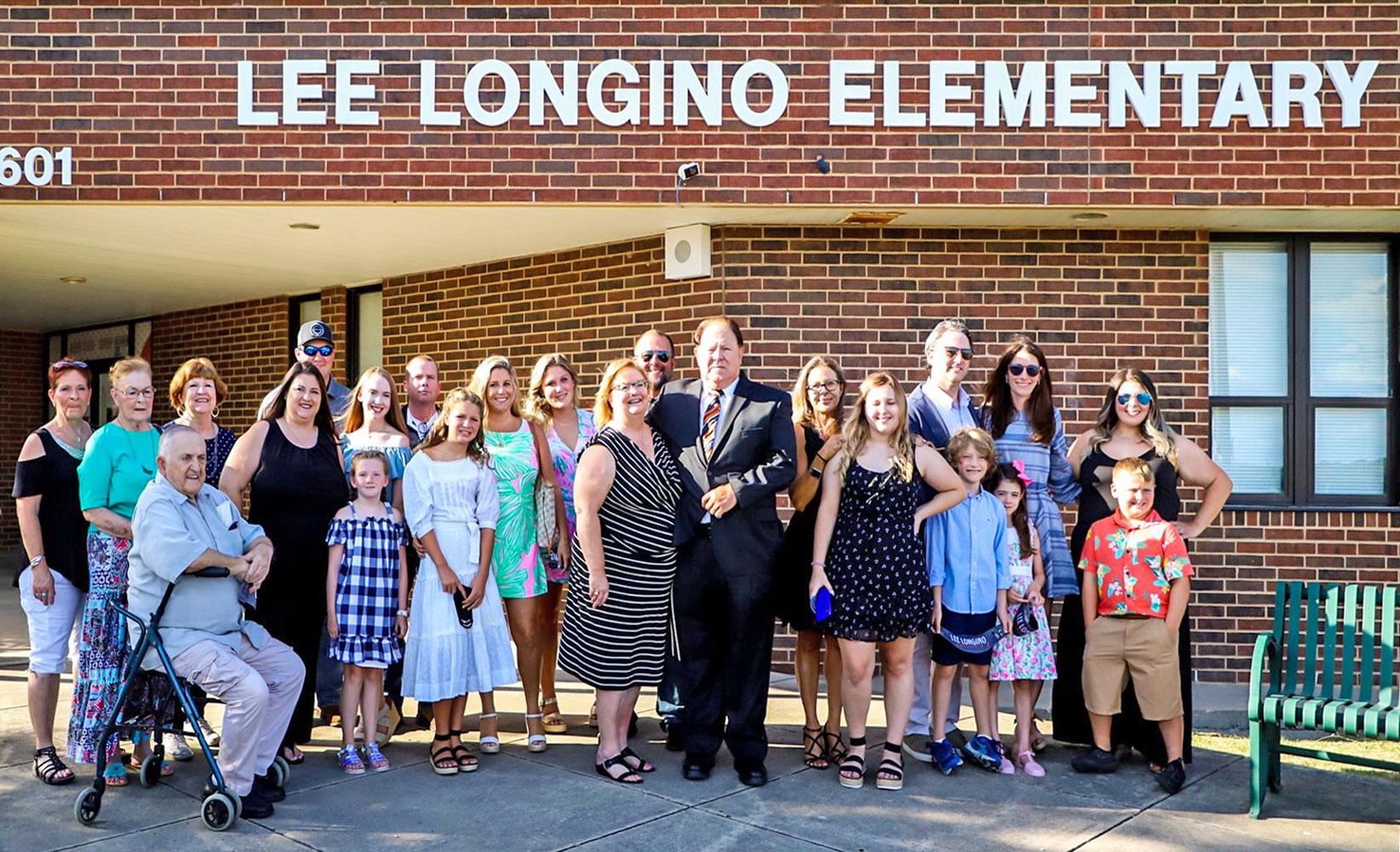 Honoree Lee Longino surrounded by his family at the school dedication ceremony on Tuesday, July 21.