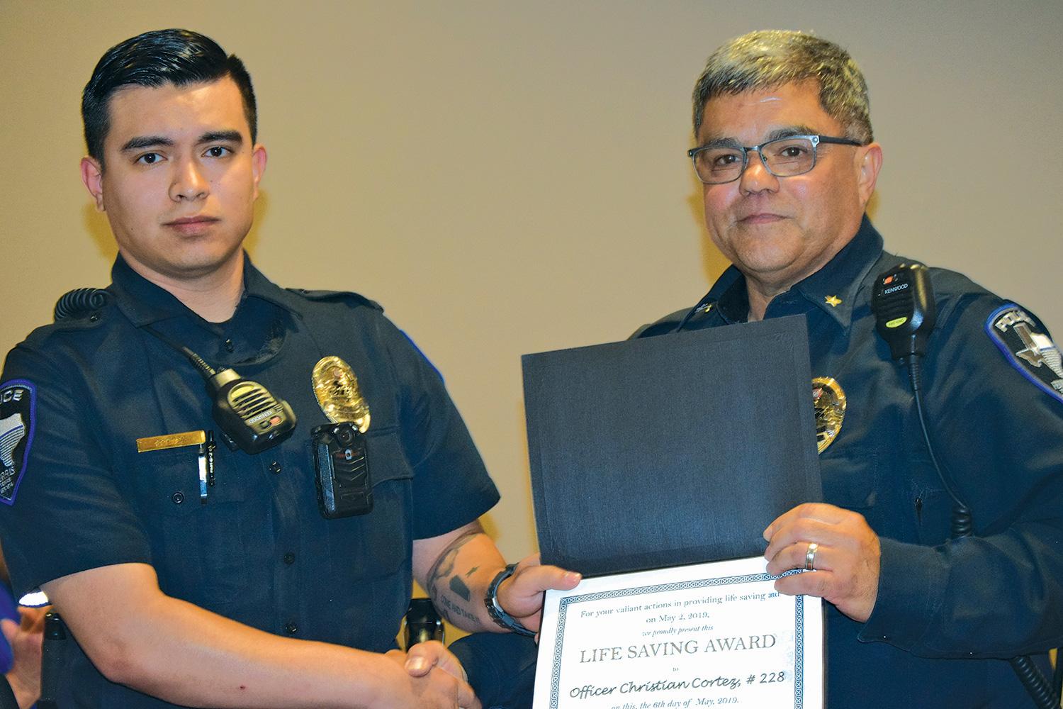 Ferris Police Chief Eddie Salazar presents Ferris Police Officer Christian Cortez with Life-Saving Award during the Monday, May 6 Ferris City Council meeting.