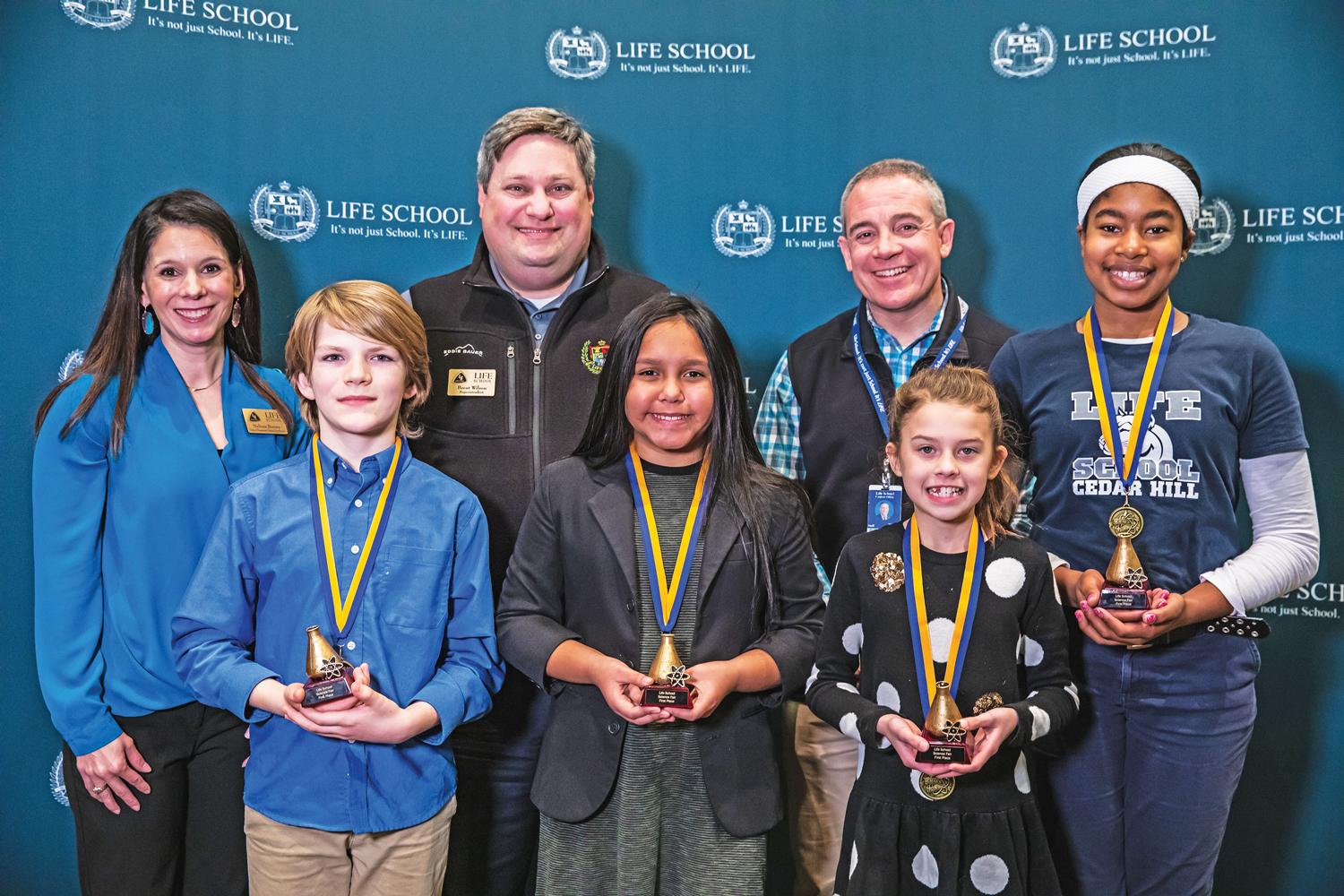 First Row: Asher Robbins, Life School Cedar Hill, Hannah Murillo, Life School Cedar Hill, Brylnn Griffis, Life School Red Oak Second Row: Melissa Brown, Elementary Science Coordinator, Brent Wilson, Superintendent, Troy Mooney, Chief Academic Officer, Natalynn Spann, Life School Cedar Hill.