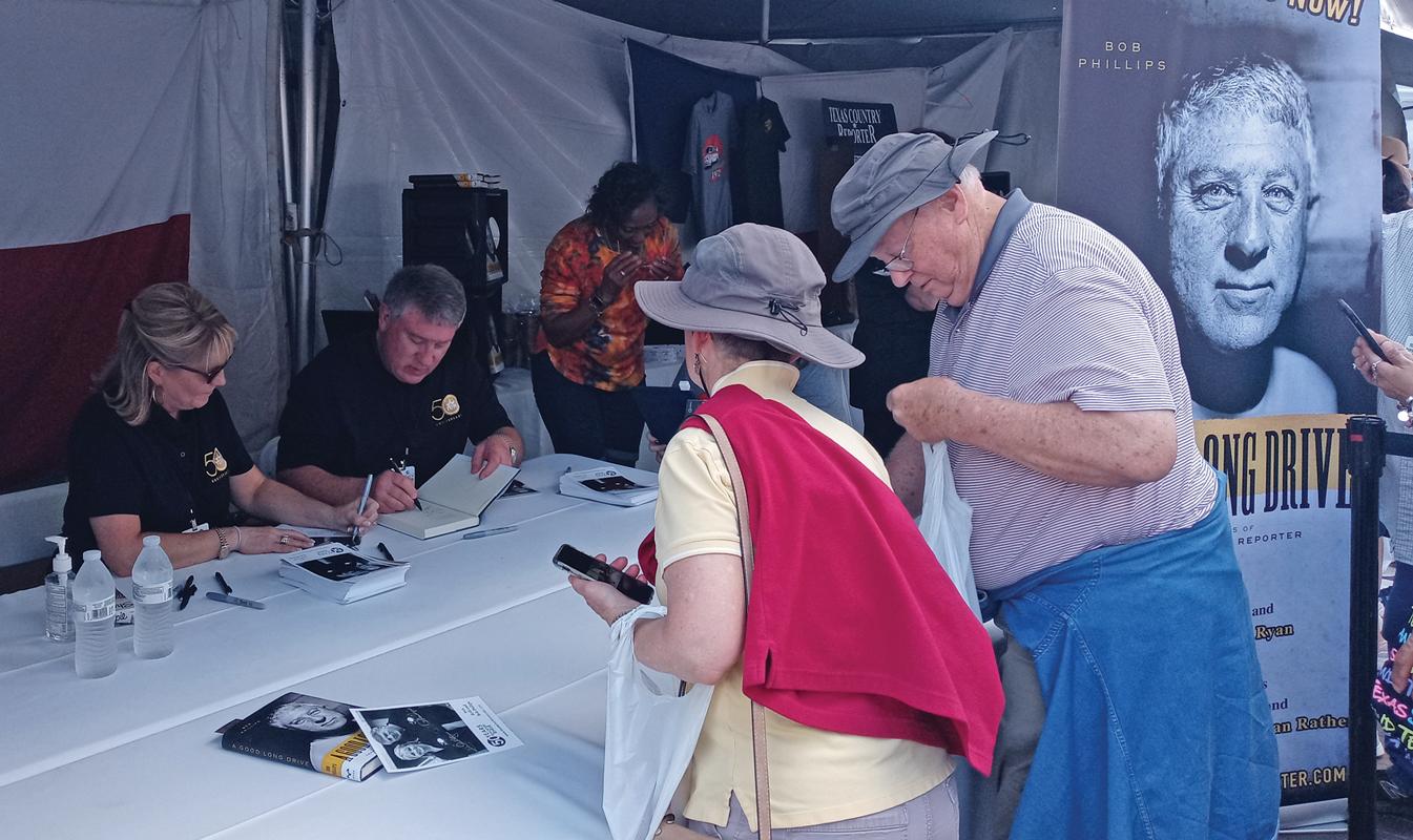 Texas Country Reporter Bob Phillips signs autographs as he celebrates 25 years of hosting the popular series. Photo by Michael Seiber.