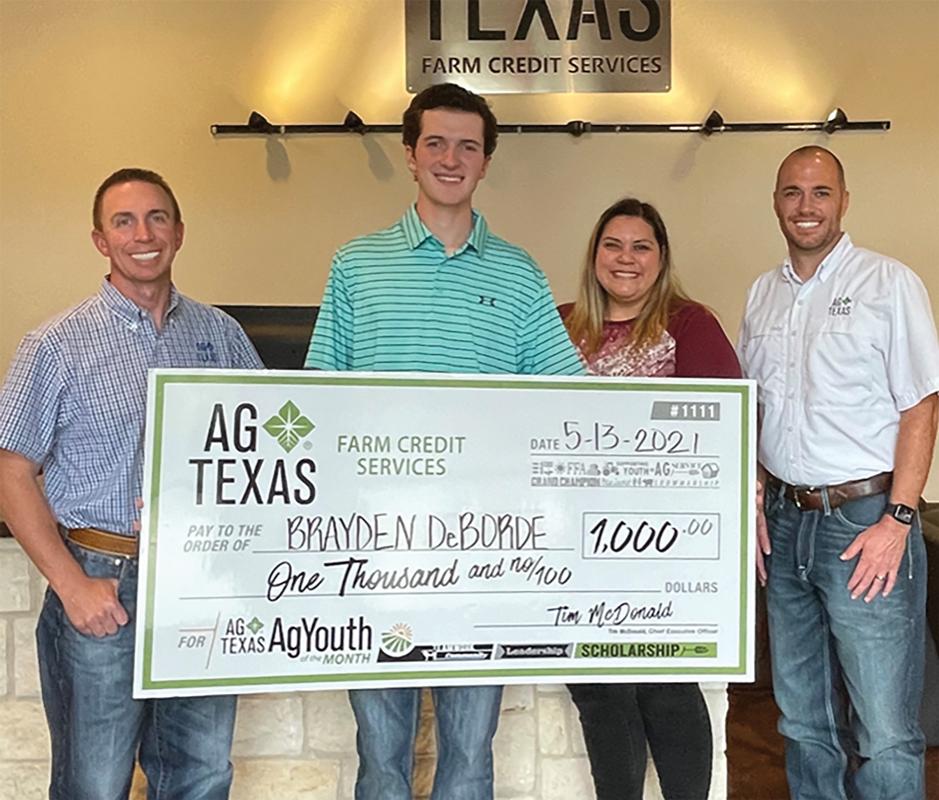 AgTexas Branch Manager Matt Thomas presents Brayden DeBorde, Ellis County 4H, with a $1,000 scholarship check.