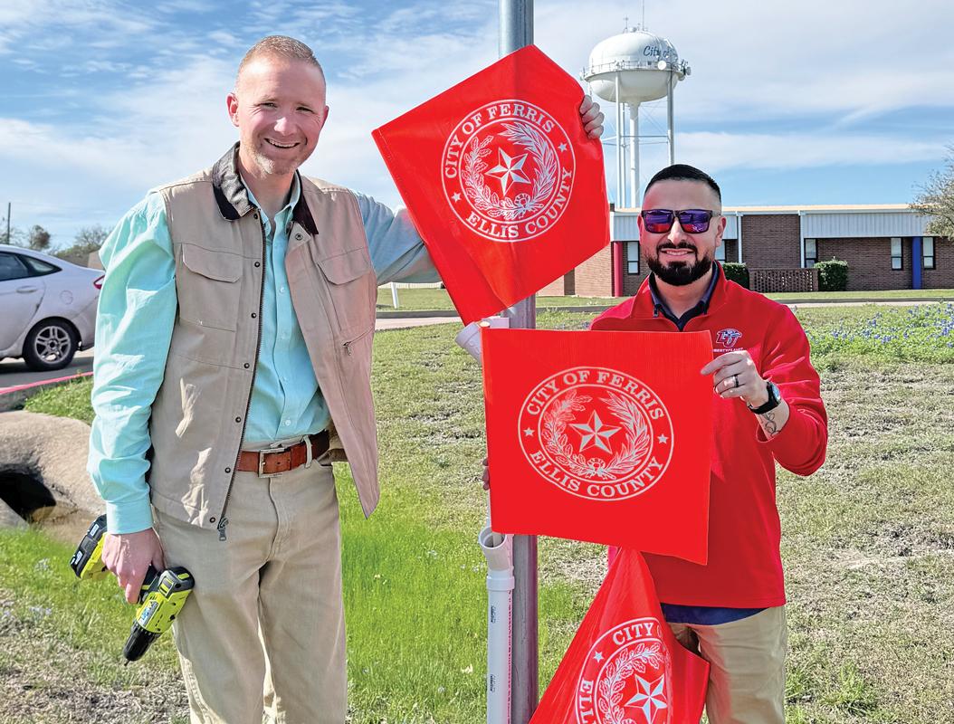 City  Manager  Brooks Williams and Asst. City Manager John DeLeon shown installing crosswalk flags.