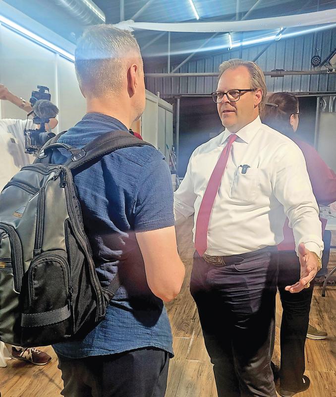 Ellis County Judge Todd Little talks with Russian Independent journalist Akexey Pivoparov at last week’s GOP meeting.