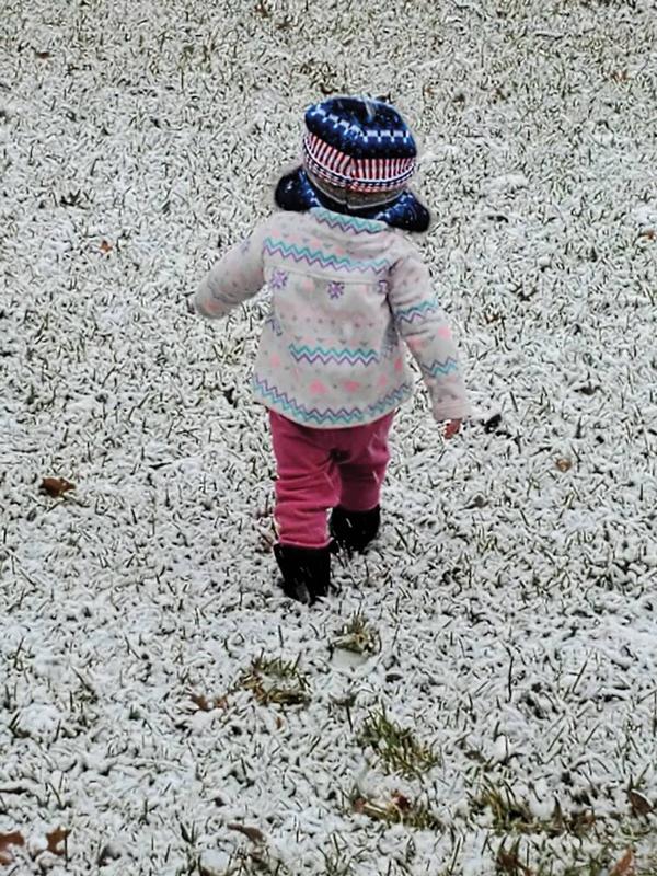 A little girl (unnamed) in Italy takes her first steps in the three-inches of snow that fell Sunday.