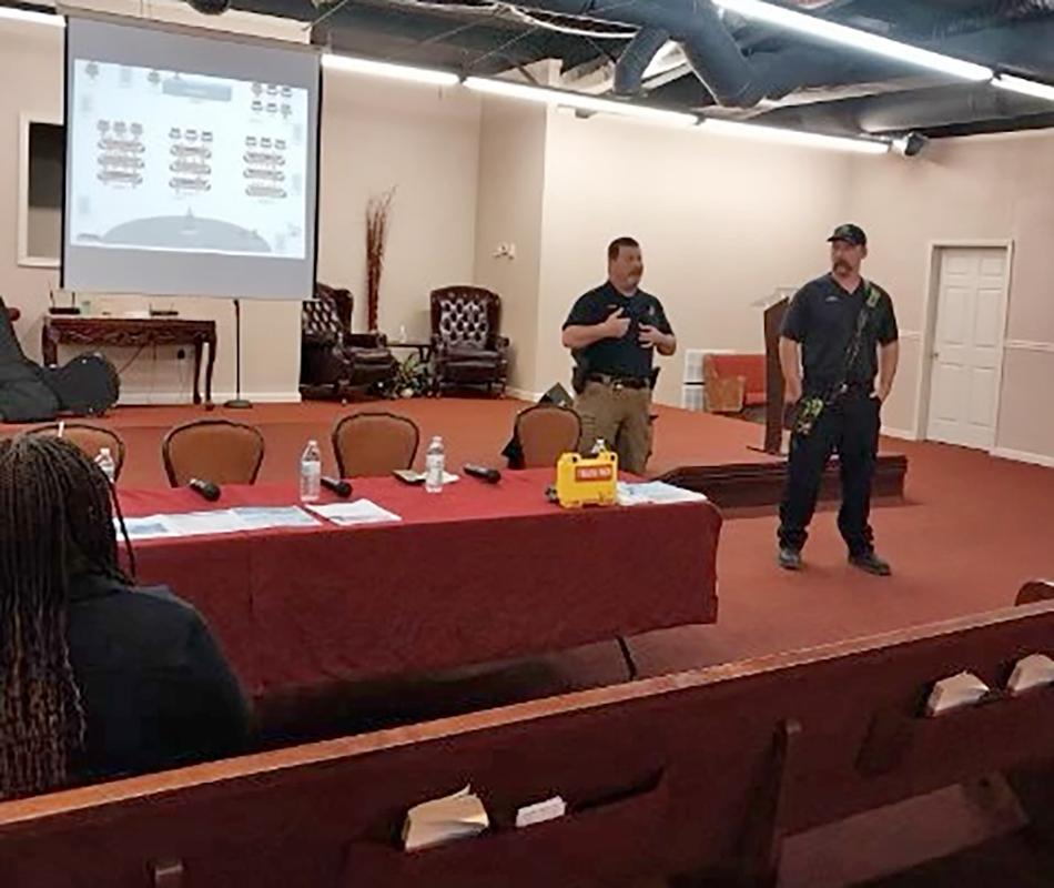 Red Oak Police Chief Garland Wolf alongside Captain Loss Horn with Red Oak Fire Rescue on March 11 at Refuge Temple Ministries in Red Oak. Photo courtesy Red Oak Police Department. 