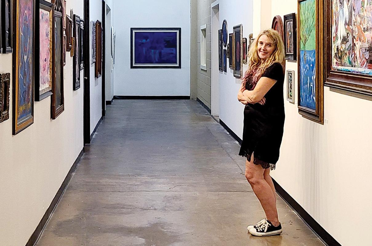 Rita Cook poses in her self-portrait mirror series which opened at E Gallery on Sept. 1, and will display her work until Feb. 28, 2023.