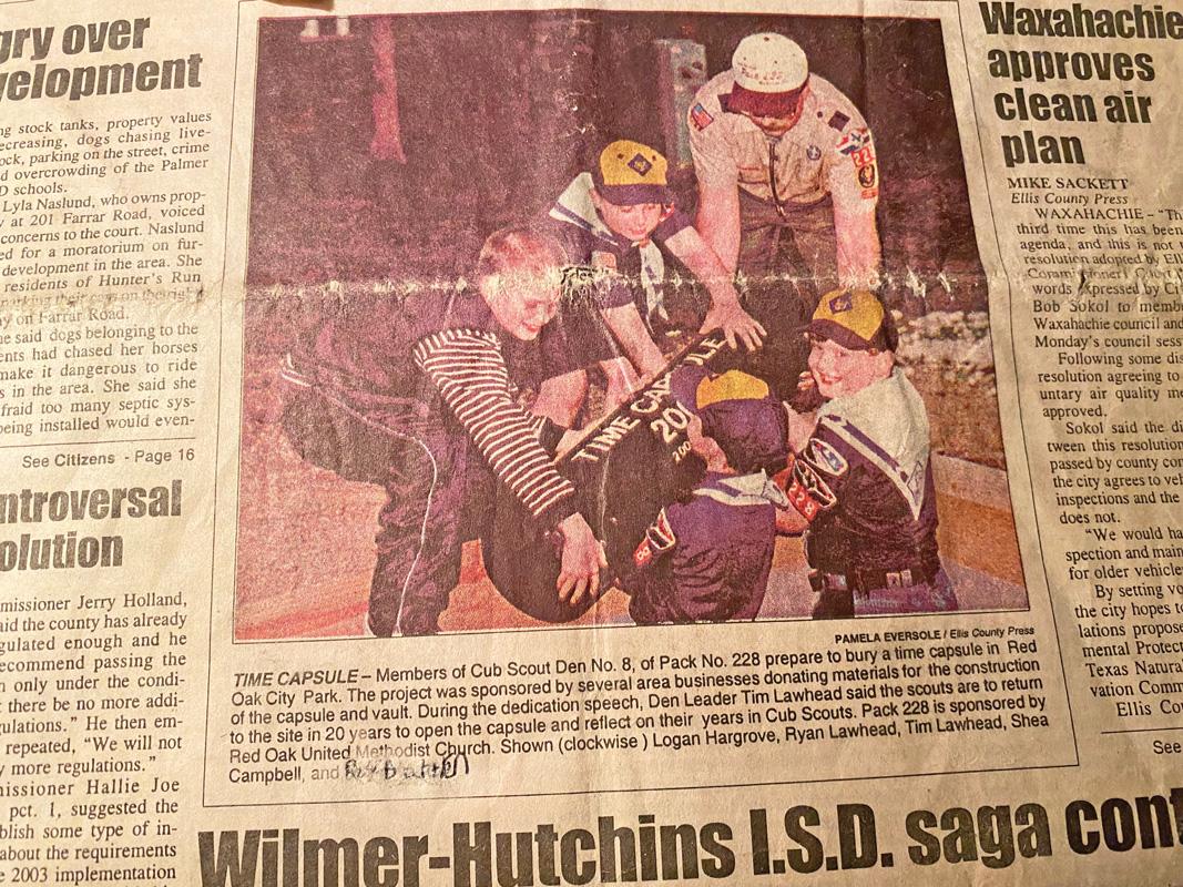 A clipping retrieved from a 22-year-old Ellis County Press newspaper showed a picture of the burial of the capsule.