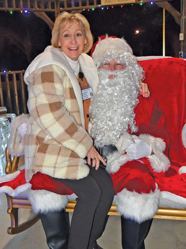 Ovilla City Manager Pam Woodall tells Santa what the city wants for Christmas during the Christmas tree lighting celebration at Ovilla Heritage Park in the downtown area of Ovilla on December 1.