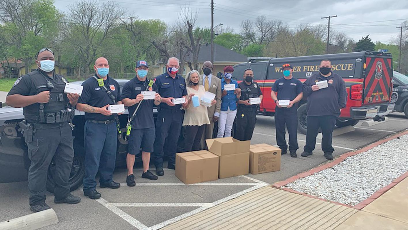 Two members of the Wilmer Fire Department are shown with Mayor Sheila Petta and Jewel Manzay from State Representative Carl Sherman’s office.