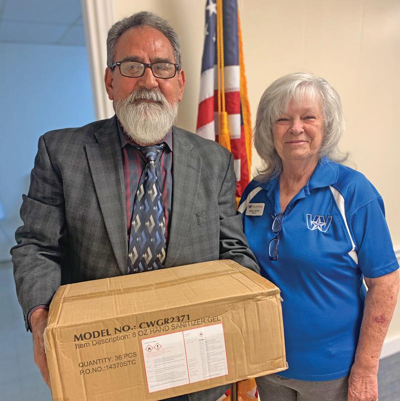 Councilman Sergio Campos and Mayor Sheila Petta prepare to distribute hand sanitizers.