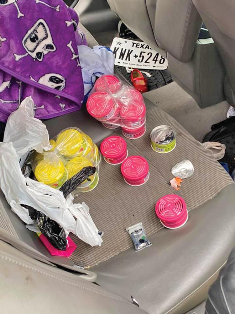 The vehicle search produced approximately 25 to 30 small canisters of what on the outside appeared to be air fresheners. 