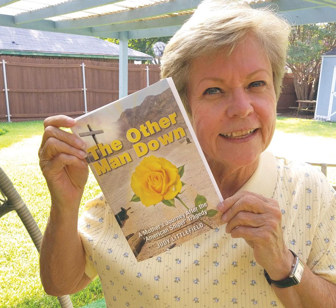 Judy Littlefield, the mother of Chad Littlefield, holds a copy of her newly released book.