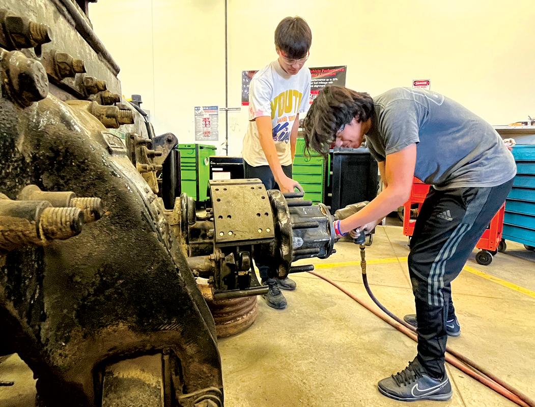 Angel Castillo (right) removes bolts as Robert Medina Jr. observes during a Diesel Equipment Technology lab session at Texas State Technical College’s North Texas campus. Both Castillo and Medina are Waxahachie High School seniors taking dual credit classes at TSTC. Photo courtesy TSTC.