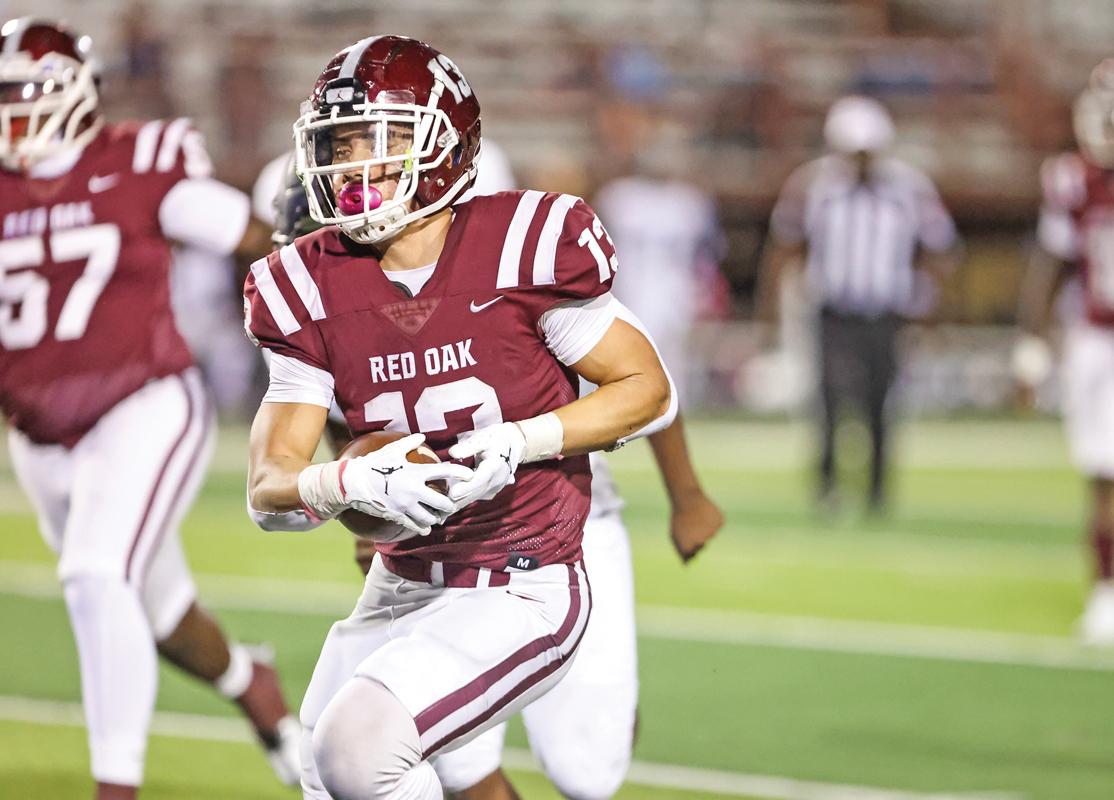 Chris Martinez (13) runs past the Hawks sideline on his way to a 22-yard touchdown run.