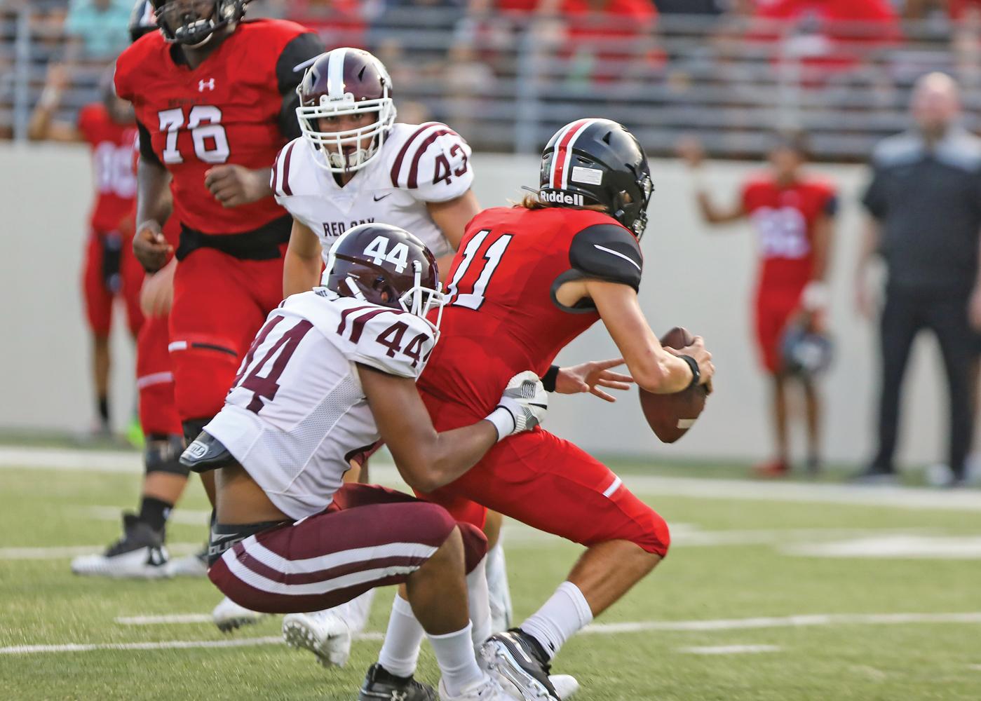 Hawk Defensive End Todd Tillis (44) collects one of the few sacks on Bengal Quarterback Greyson Thompson (11) during Red Oak’s season opener Thursday, Aug. 29. Denton Braswell went on to stun No. 17 Red Oak, 48-27.