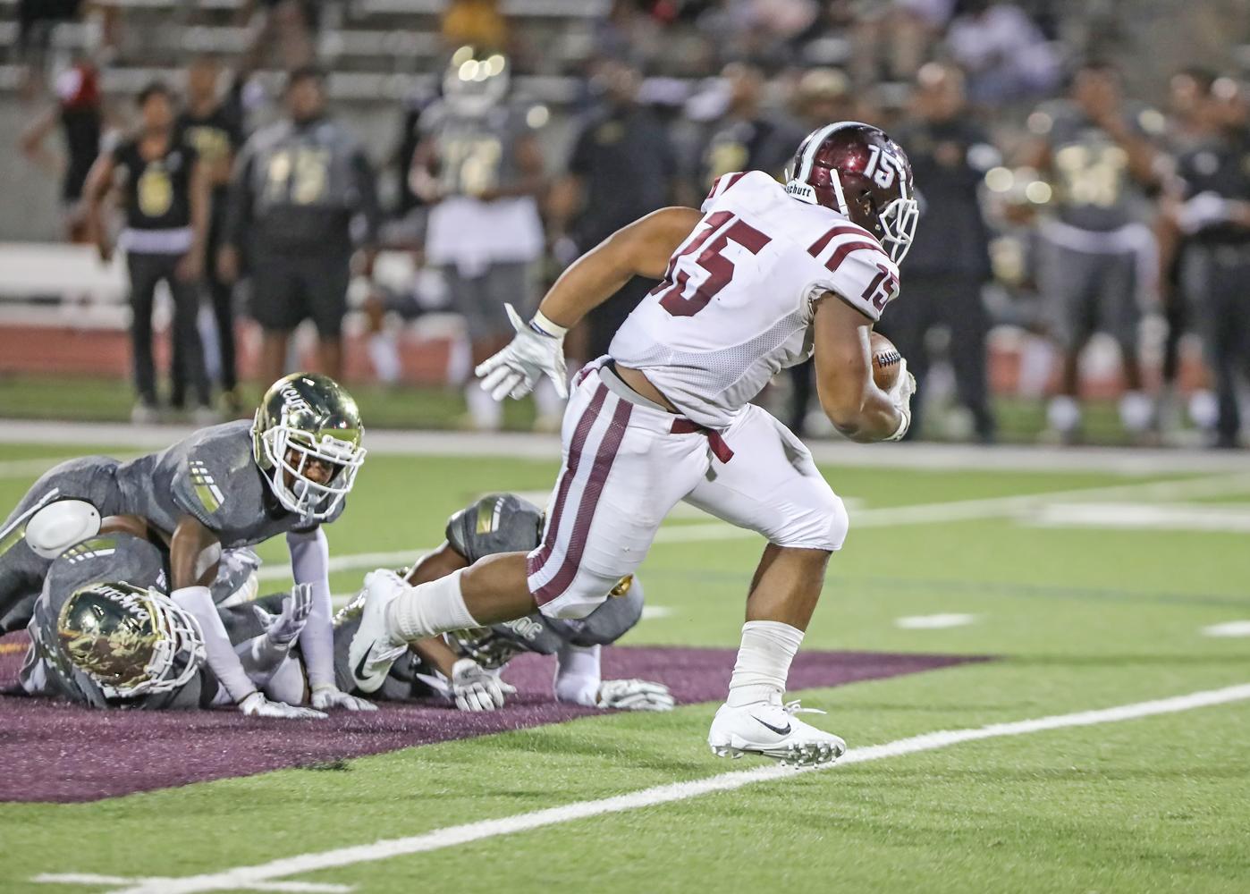 CJ Palmer (15) scored on this run up the middle after powering through multiple tackle attempts.