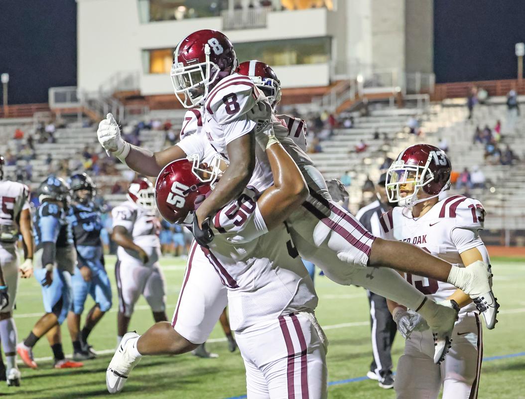 Hawk Senior RB Moses Martindale (8) is lifted into the by Offensive Lineman Ashton Scott (50) after scoring a late 4th quarter touchdown, sealing the 35-25 win for Red Oak.
