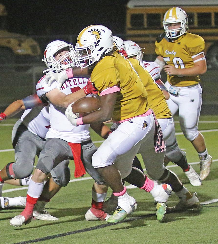 Italy tailback #2 Jaiden Barr strongarms an Axtell defender. Barr finished the game with 203 yards rushing on 17 carries, scoring 4 touchdowns. Photo by Barry Byers / Italy ISD Art Departments.