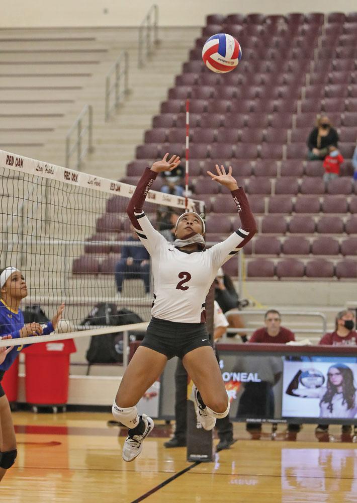 Makinzie Taplin (2) sets the ball for an outside hitter in the game against Corsicana. Photo by Steve Patterson / Moving Pictures.