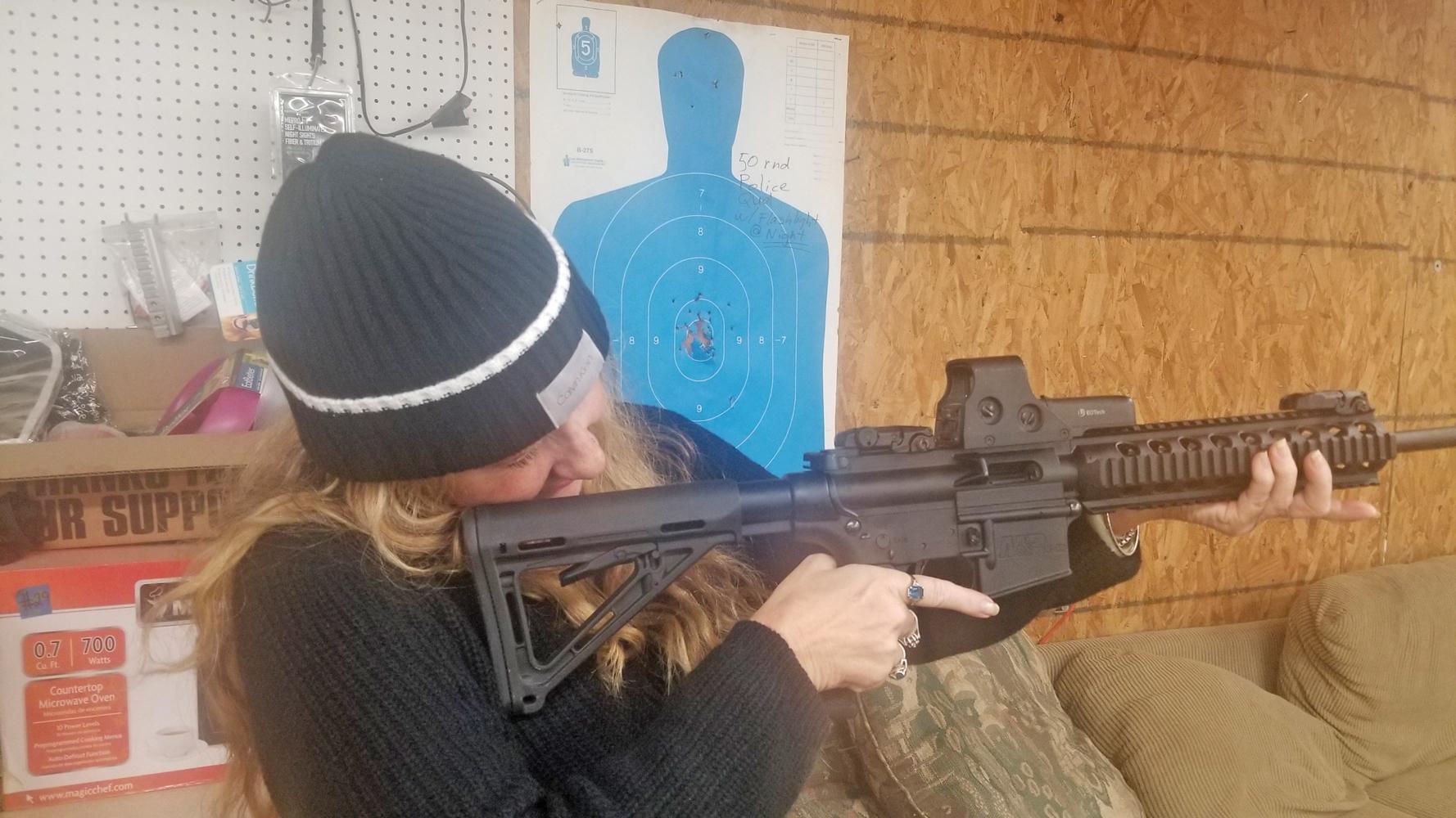 News Editor Rita Cook holds an AR-15 semi-automatice carbine for the first time at Texas Defensive Shooting Academy near Ferris.