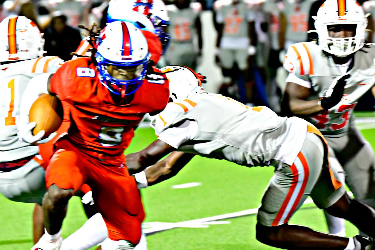 Heritage’s Za’ko Davis (8) had 22 carries for 119 yards and two touchdowns in the losing effort. Photo by Fred Phipps.