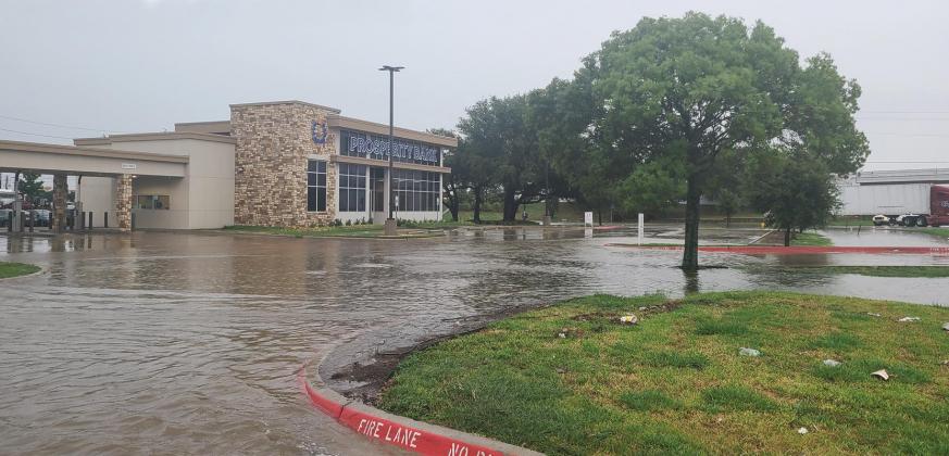 Torrential rain flooded roads and highways Monday, including this bank parking lot in Red Oak at the corner of Interstate 35 SR and Ovilla Road.