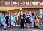 Honoree Lee Longino surrounded by his family at the school dedication ceremony on Tuesday, July 21.