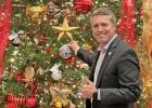 State Representative Brian Harrison places the 2022 House District 10 Christmas ornament on Christmas tree on the Floor of the Texas State House of Representatives.  