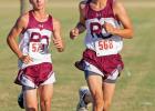 Two members of the Red Oak High School boys Cross Country Team pass the 1-mile marker during the Life School Stampede at the Waxahachie Sports Complex.