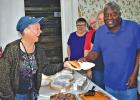 Councilman Tommy Scott serves BBQ at the Ferris Senior Center Wednesday, May 29.
